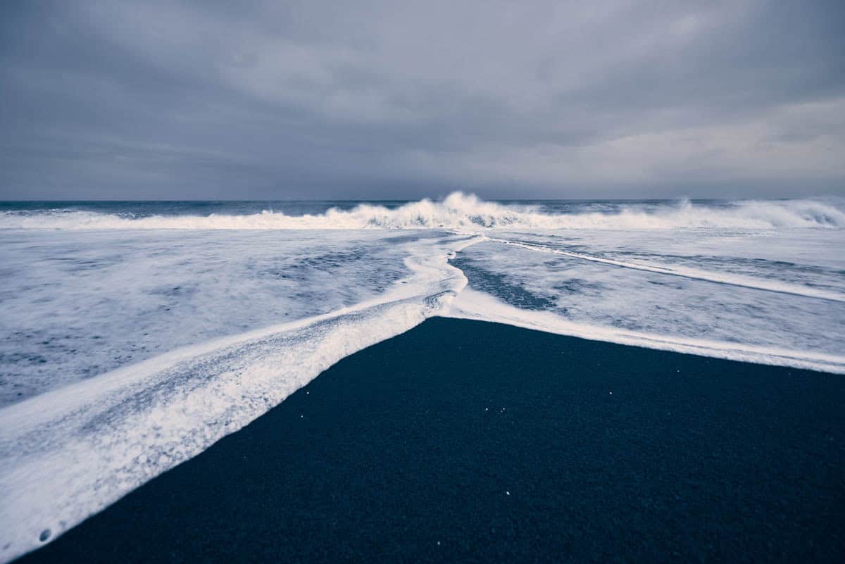 Surf meets black sands at Reynisfjara Beach in Iceland